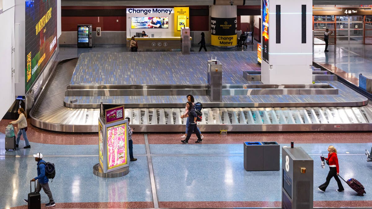 Travelers make their way through the baggage claim at Harry Reid International Airport on Tuesday, Nov. 11, 2025, in Las Vegas.