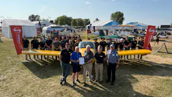 The Van's Aircraft team joines Van's Aircraft founder Dick VanGrunsven (front row, center) and EAA CEO/Chairman Jack Pelton (front row, second from left) on July 24, 2026, as the first MOSAIC-compliant RV-12 is delivered during EAA AirVenture Oshkosh 2026. Front row: Left to right: Mikael Via, Van’s Aircraft CEO; Pelton; VanGrunsven; Rian Johnson, Van’s Chief Engineer; and Designated Airworthiness Representative (DAR) Bill Kanino.