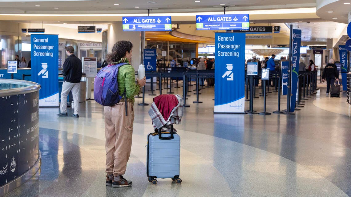 A passenger stands at the Boise Airport in December 2025. The city is searching for the airport&rsquo;s next leader.