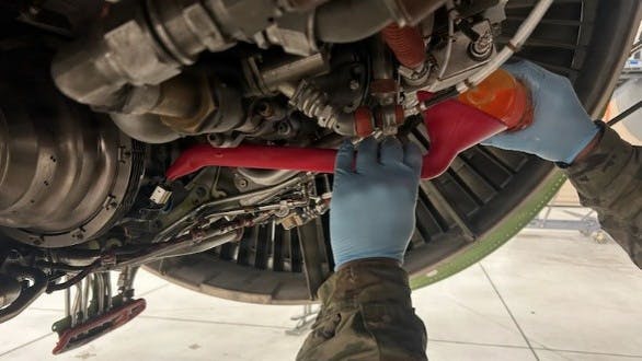 A thermoplastic polyurethane fuel funnel is used to service an engine starter at McConnell Air Force Base, Kan., July 17, 2026. The 3D-printed TPU funnel was created by McConnell's Innovation Lab to increase servicing efficiency while doing maintenance on engine starters by maintenance professionals.