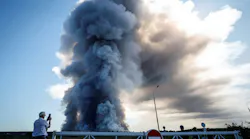 A local resident takes a picture of the smoke from a fire at the Russian e-commerce firm Wildberries' logistics complexes in the town of Elektrostal outside Moscow on July 18, 2026.