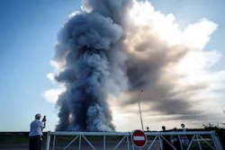 A local resident takes a picture of the smoke from a fire at the Russian e-commerce firm Wildberries' logistics complexes in the town of Elektrostal outside Moscow on July 18, 2026.