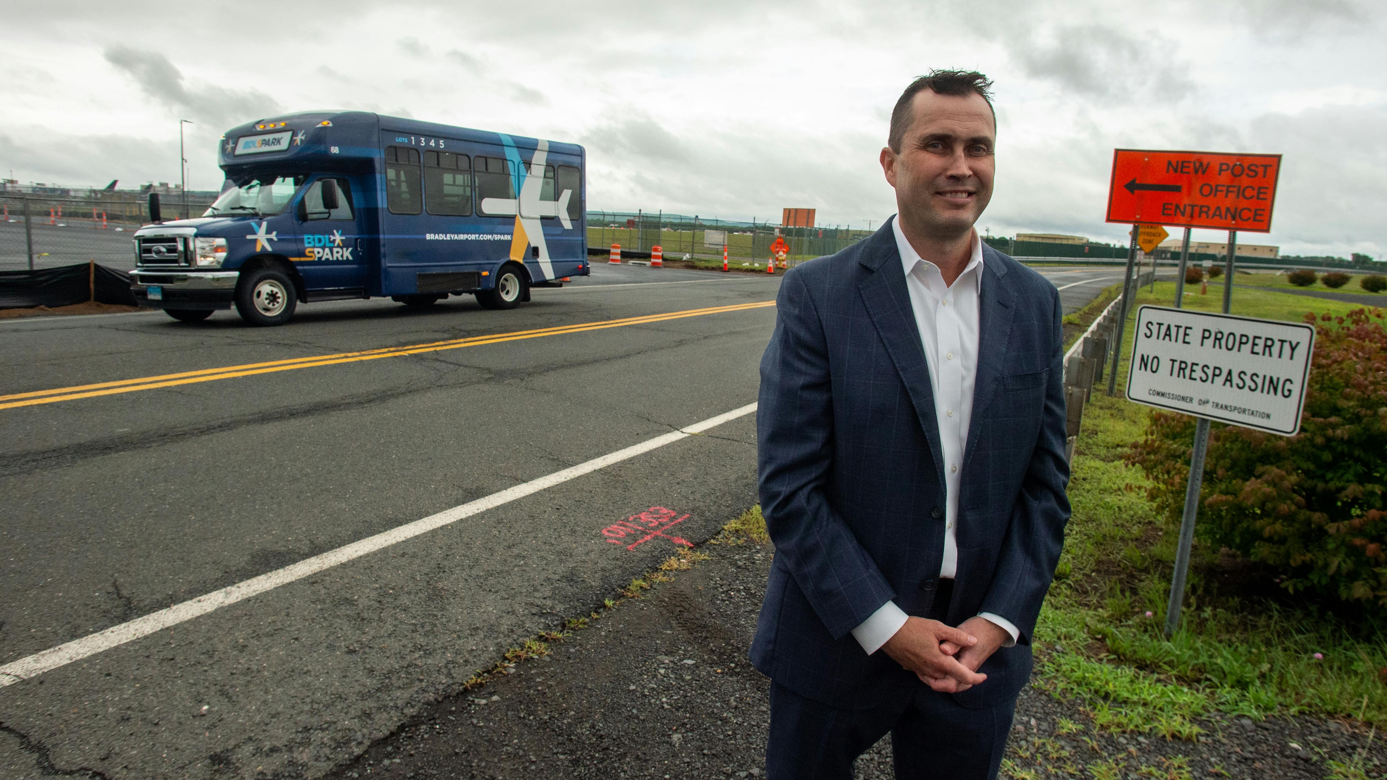 Michael Shea, Connecticut Airport Authority executive director and CEO, discusses the new Lot 3 parking area as a BDL sPARK shuttle bus passes by at Bradley International Airport.
