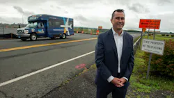 Michael Shea, Connecticut Airport Authority executive director and CEO, discusses the new Lot 3 parking area as a BDL sPARK shuttle bus passes by at Bradley International Airport.