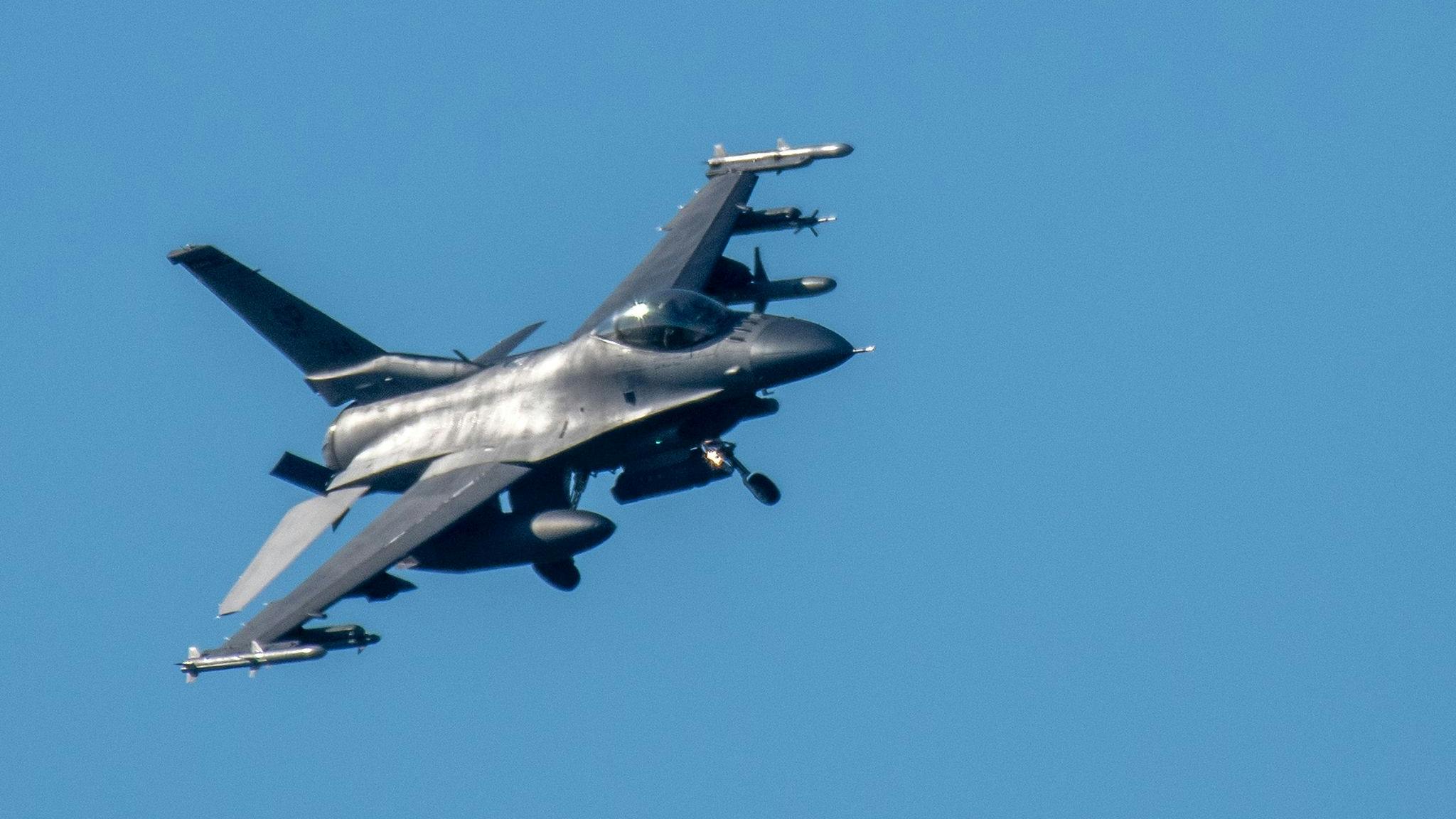 An F-16 Fighting Falcon fighter aircraft extended its landing gear to land at the US military airfield at Spangdahlem.