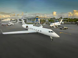 An aerial photograph of a facility with white airplanes parked in front of it