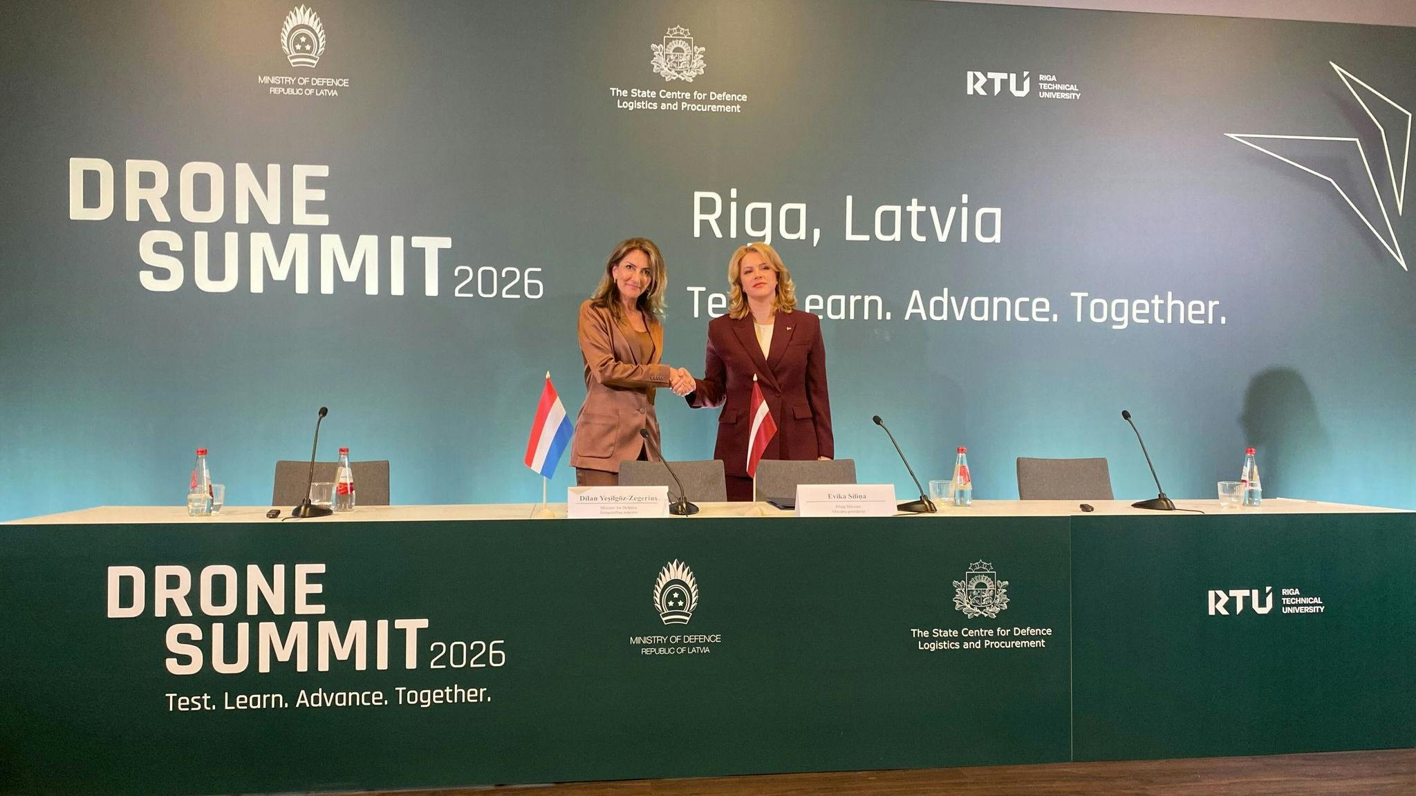 Latvian Prime Minister Evika Silina (R) and Dutch Defense Minister Dilan Yesilgoez-Zegerius sign a declaration on closer drone cooperation.