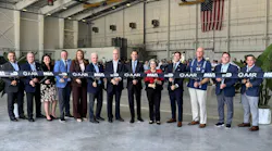 A line of people wearing business attire holding onto a ribbon that says 'AAR' and 'MIA' on it