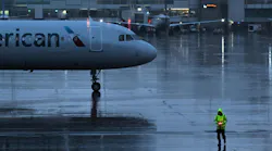 Ground crew work as the rain begins to fall in anticipation of the upcoming snow storm at Denver International Airport in Denver on March 13, 2024.