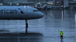 Ground crew work as the rain begins to fall in anticipation of the upcoming snow storm at Denver International Airport in Denver on March 13, 2024.