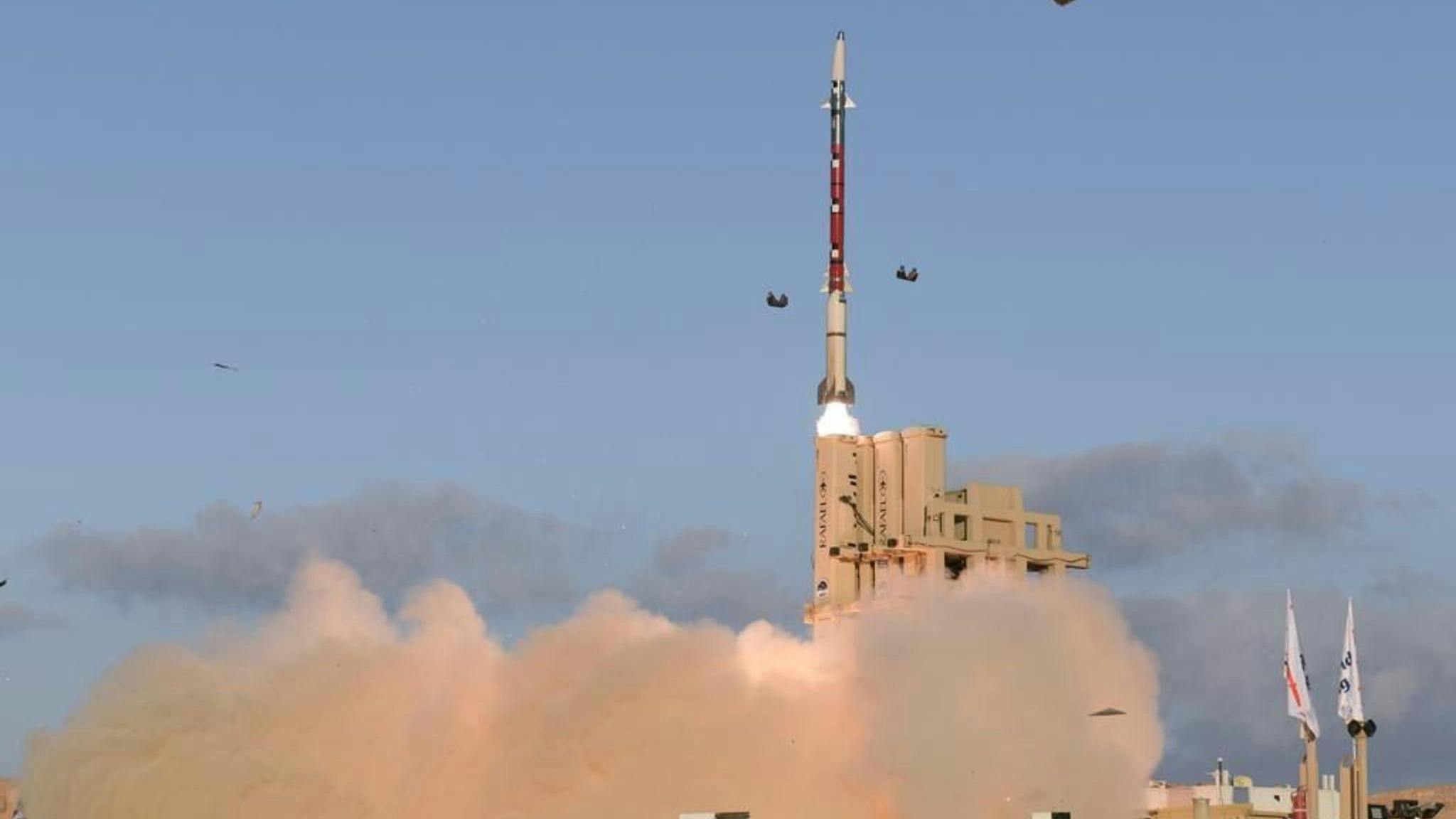 A missile launching with clouds of dust coming out from the bottom