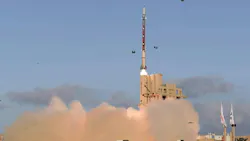 A missile launching with clouds of dust coming out from the bottom