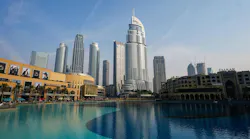 A landscape view of a city with large buildings and a body of water