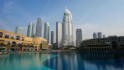 A landscape view of a city with large buildings and a body of water