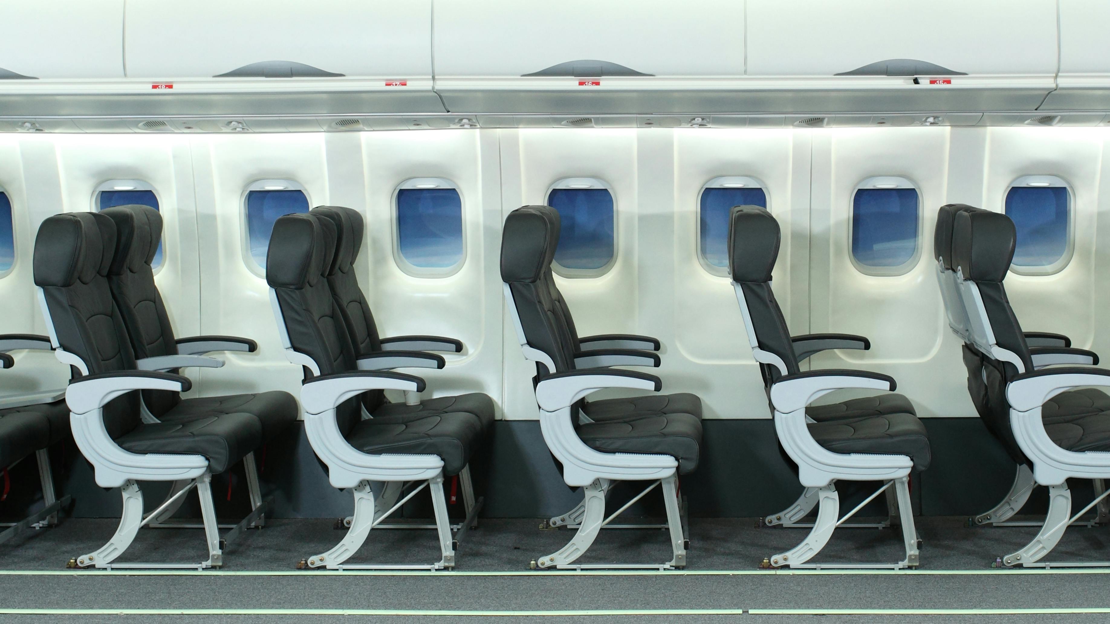 A side view of multiple rows of seats on an airplane