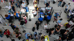 People wait in a security line at John F. Kennedy International Airport on Aug. 12, 2026, in the Queens borough of New York City.