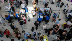 People wait in a security line at John F. Kennedy International Airport on Aug. 12, 2026, in the Queens borough of New York City.
