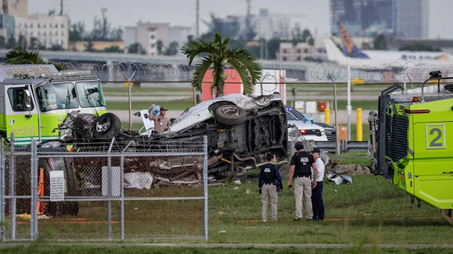 A crash site showing wreckage of an airplane and a van