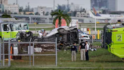 A crash site showing wreckage of an airplane and a van