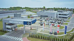 A rendering of a facility campus with a large building, parking lot and security check-in with a sign that reads: PRATT & WHITNEY