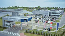 A rendering of a facility campus with a large building, parking lot and security check-in with a sign that reads: PRATT & WHITNEY
