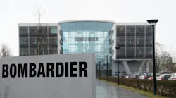 The exterior of a large glass building with a sign in front of it that reads: BOMBARDIER