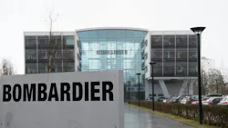 The exterior of a large glass building with a sign in front of it that reads: BOMBARDIER