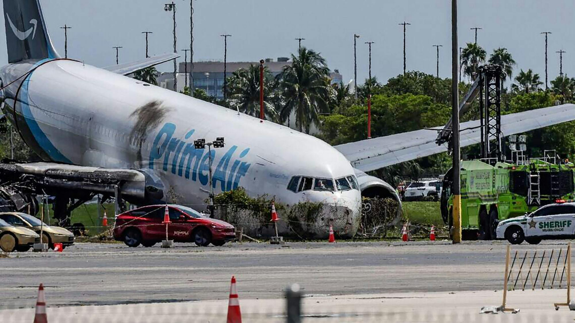 Investigators continue working on Tuesday, Sept. 8, 2026, after an Amazon Prime Air Boeing 767 went through a fence and hit vehicles at Miami International Airport on Sunday. Five people were killed.