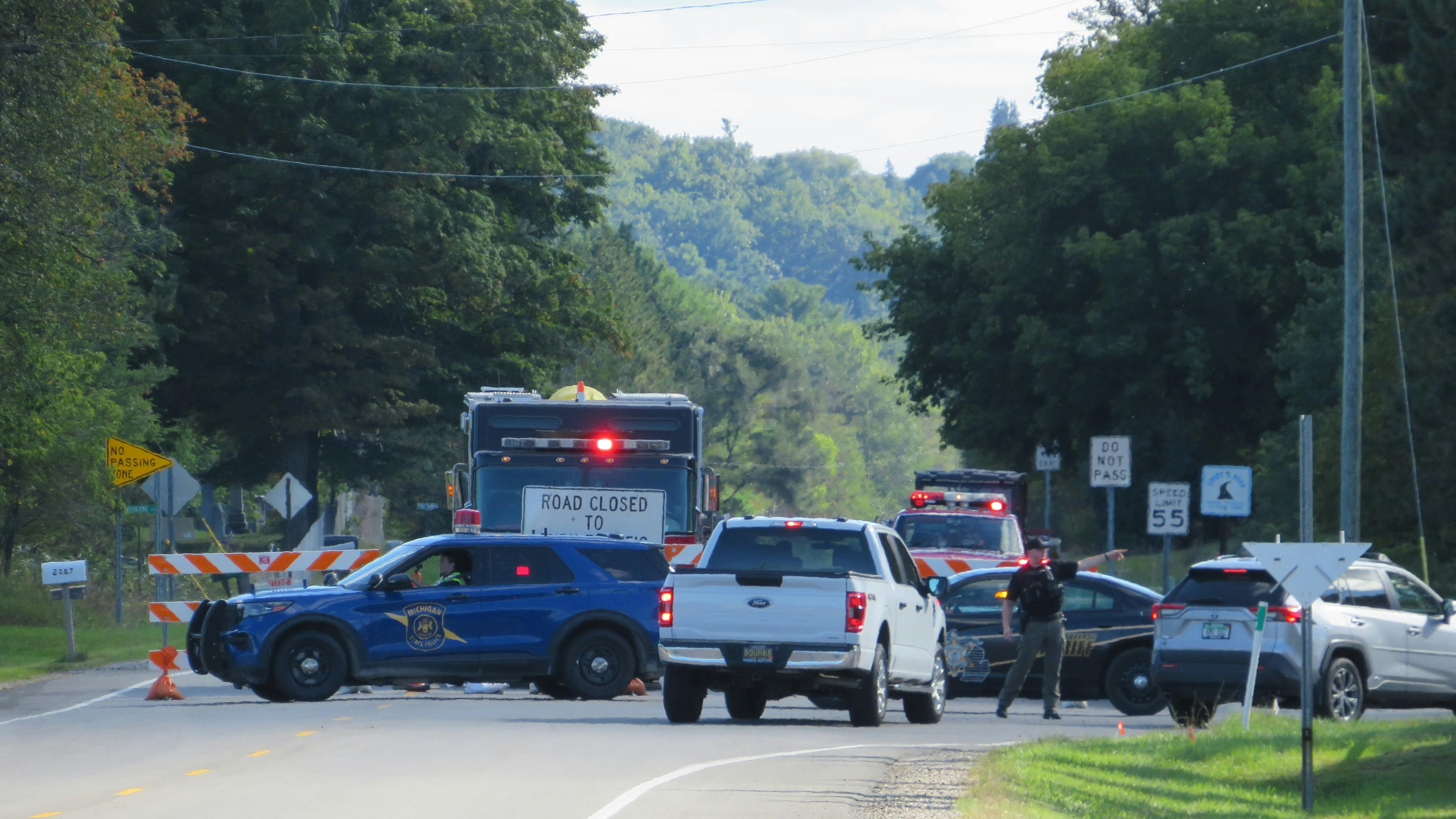 Firefighters respond to the site of an F-16 crash in Grand Traverse County, seen here at the entrance to the neighborhood where the fighter jet came down on Thursday, Sept. 17, 2026.