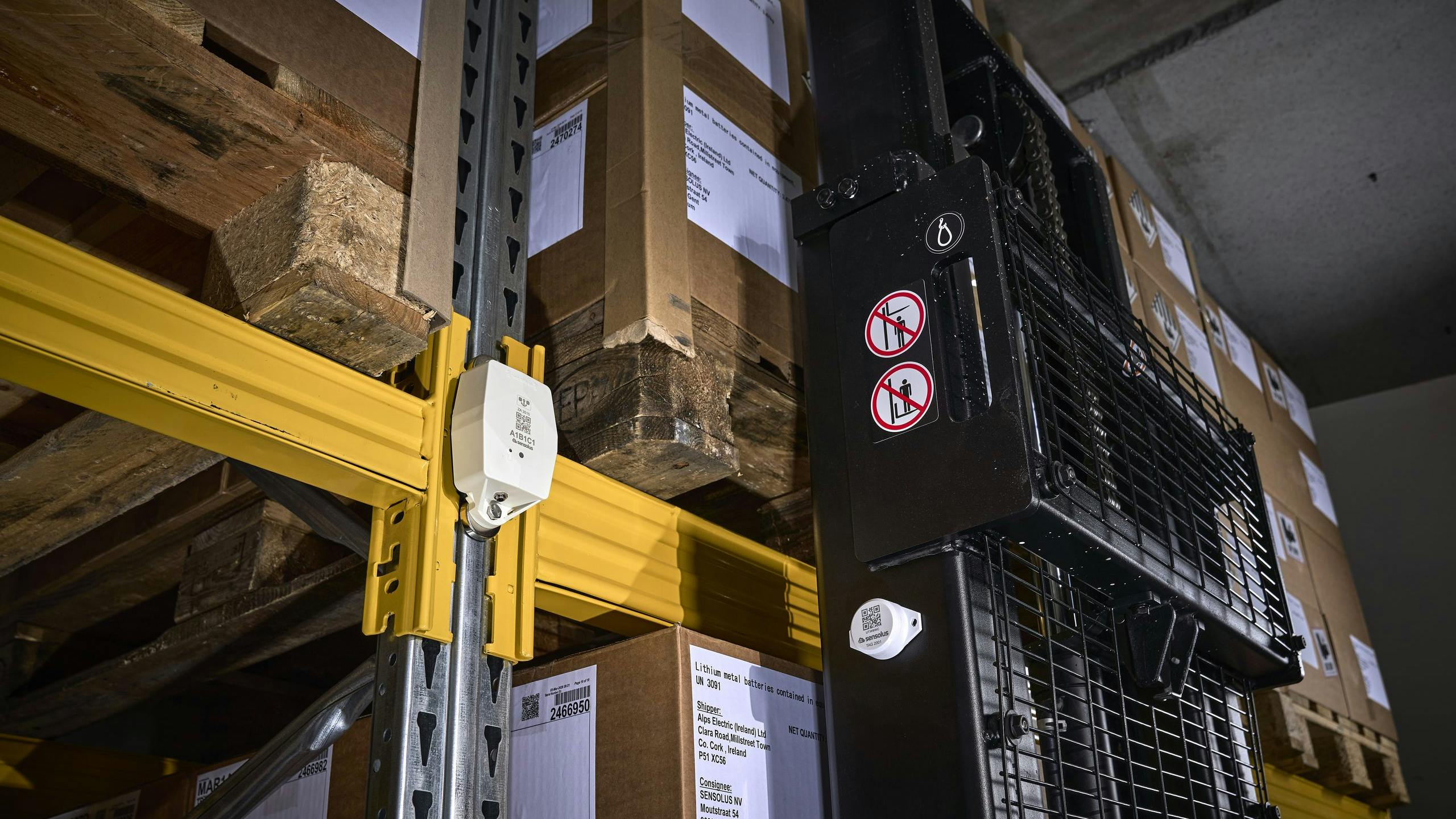 A sensor mounted on a wall in a warehouse