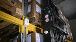 A sensor mounted on a wall in a warehouse