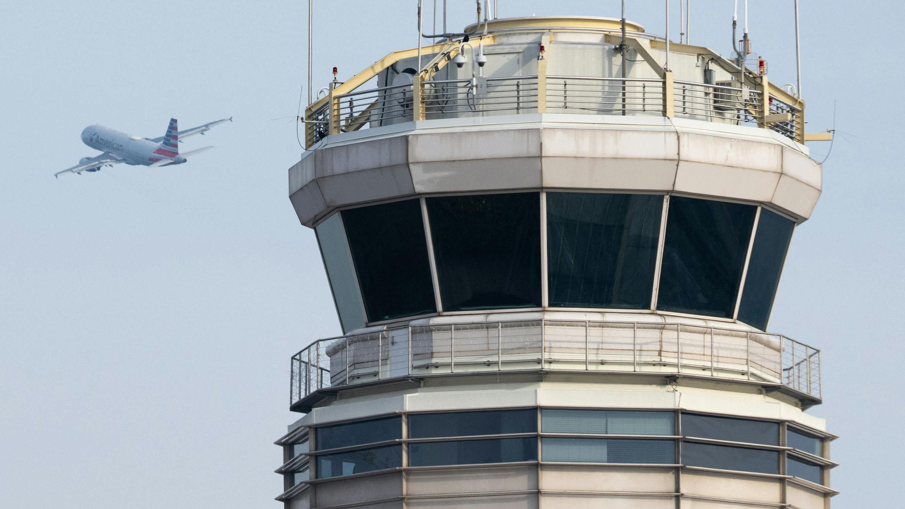 An American Airlines Airbus A319 airplane takes off past the air traffic control tower at Ronald Reagan Washington National Airport in Arlington, Va., on Jan. 11, 2023.