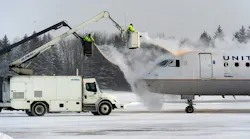 A crew sprays deicing fluid on a United Airlines plane at Syracuse Hancock International Airport in 2017.