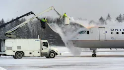 A crew sprays deicing fluid on a United Airlines plane at Syracuse Hancock International Airport in 2017.