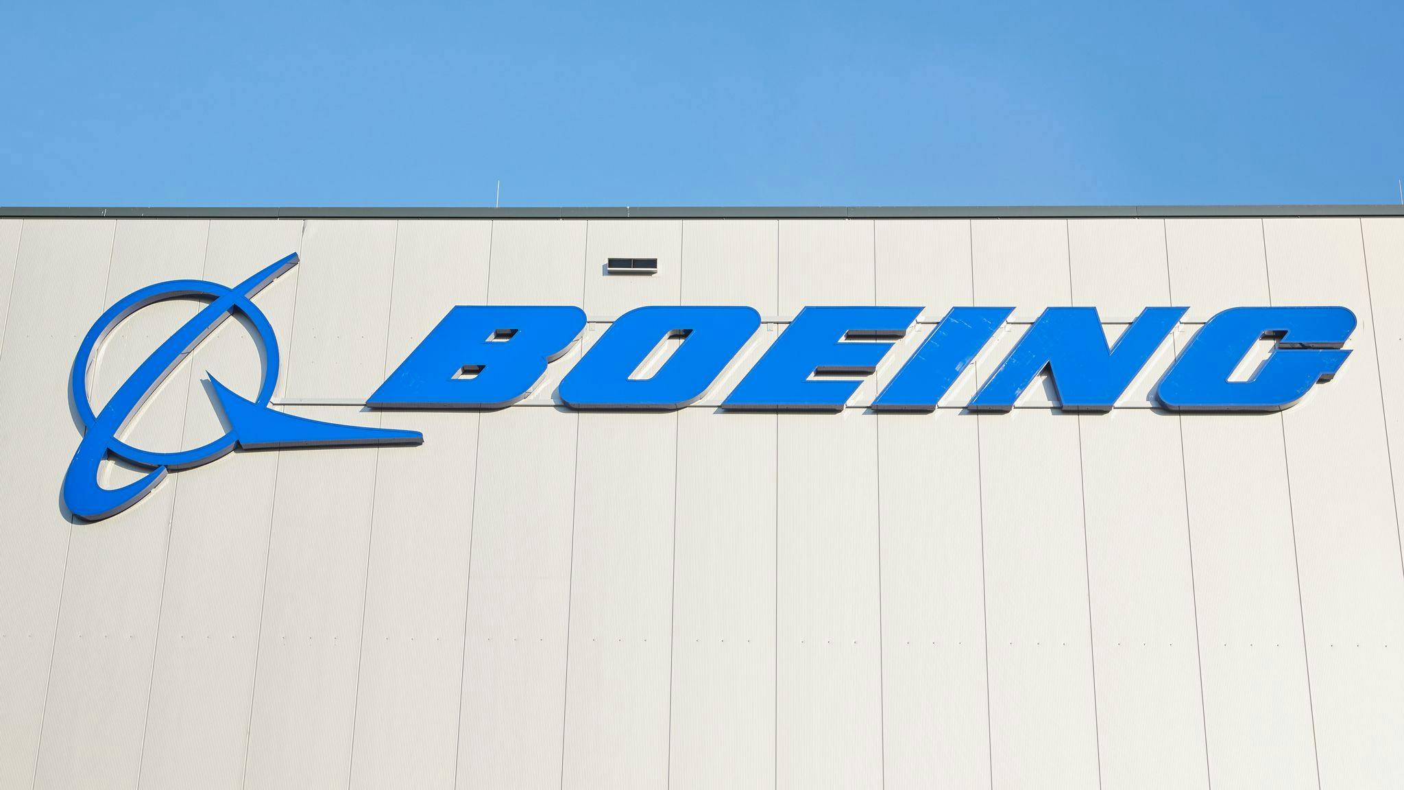 A photograph of a logo that says, 'BOEING' on the side of a building