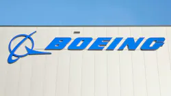A photograph of a logo that says, 'BOEING' on the side of a building