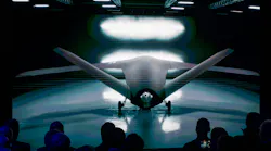 A futuristic aircraft with sharply angled wings parked in a dark hangar