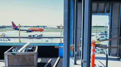 A Sun Country Airlines passenger jet taxis past the under-construction portion of Terminal 2 at Minneapolis-St. Paul International Airport in May.