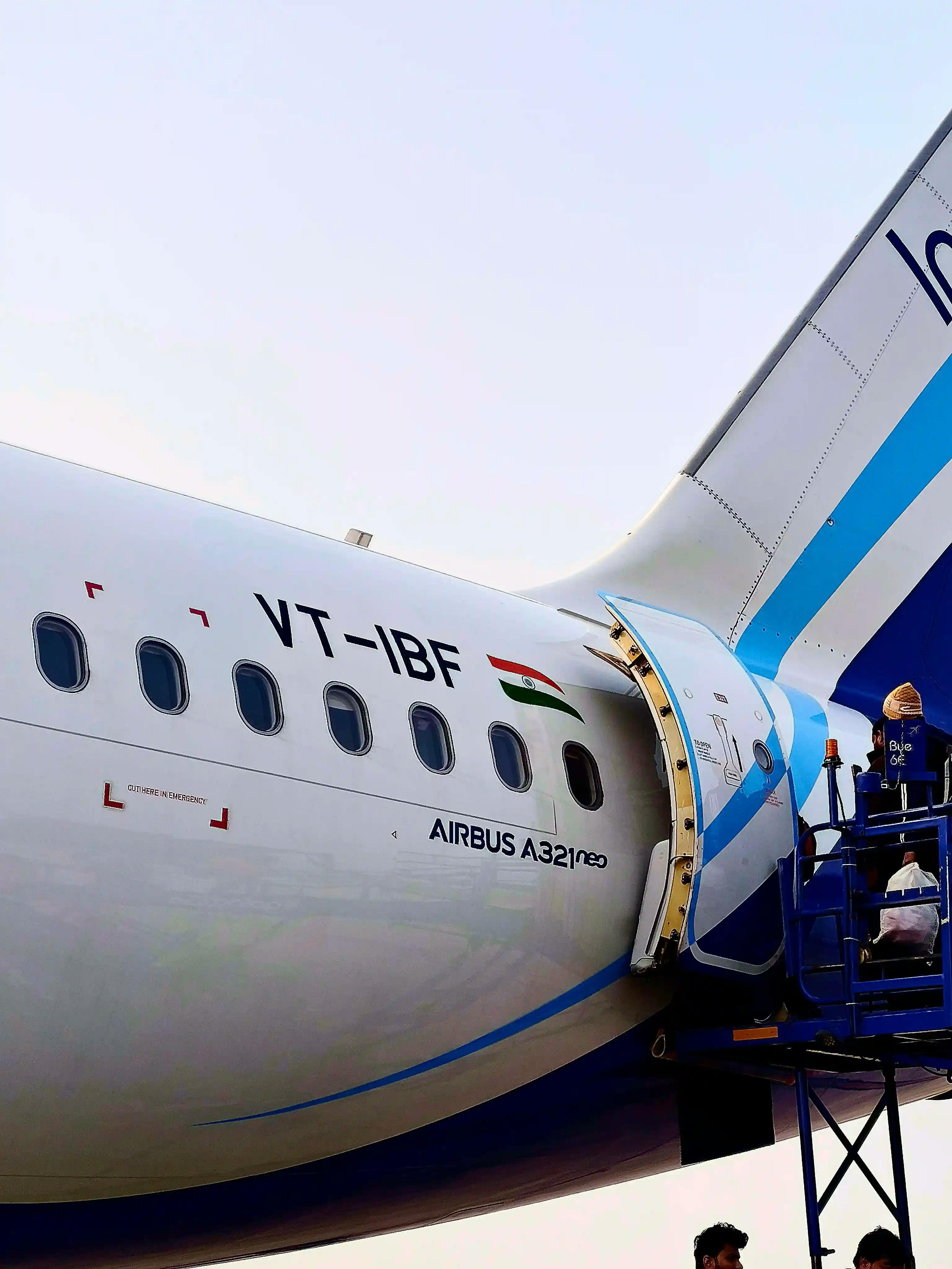 Crew Spraying An Aircraft Before Departure To Italy