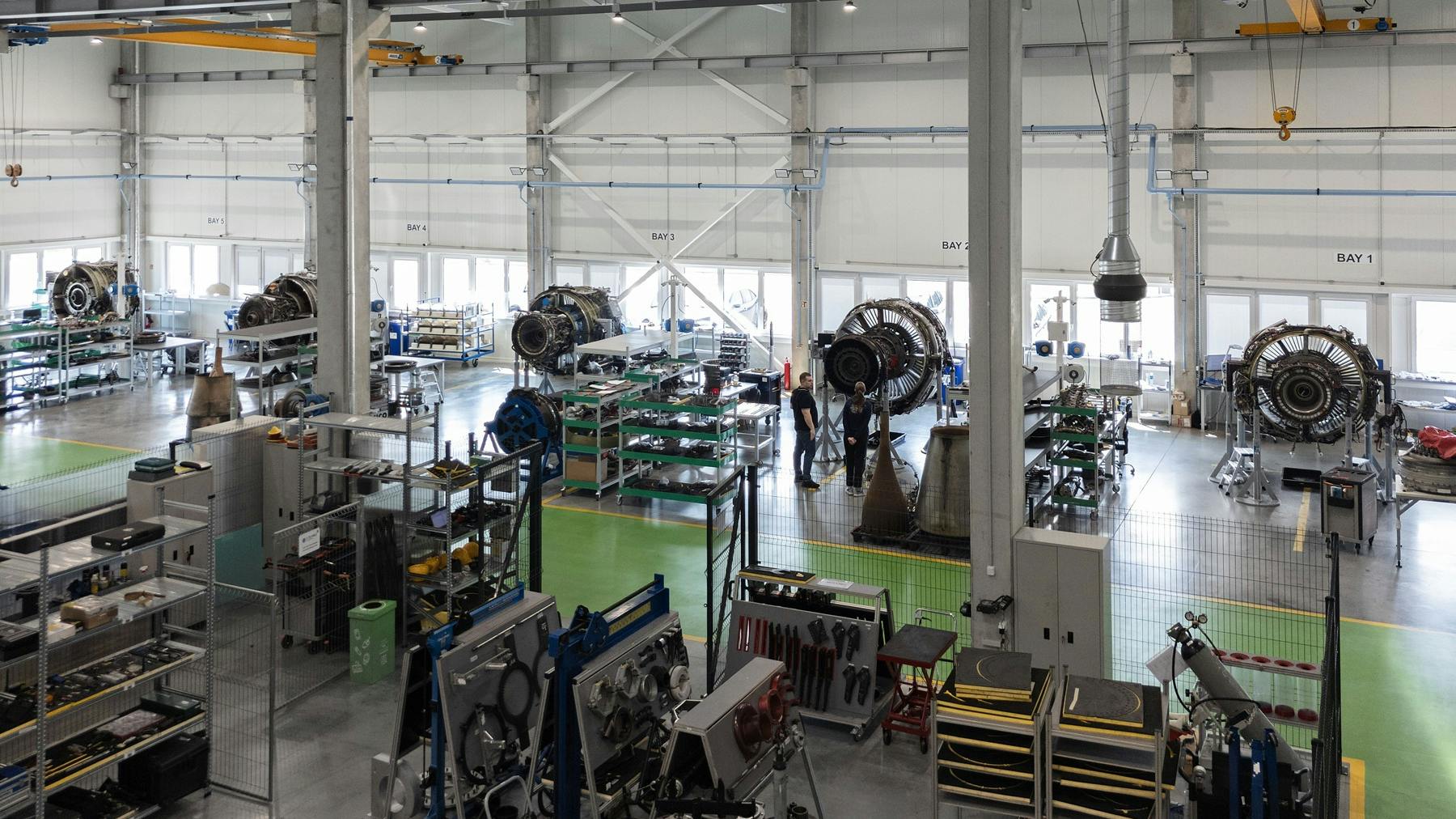 A maintenance hangar with a row of airplane engines inside