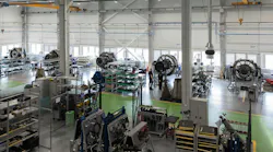 A maintenance hangar with a row of airplane engines inside