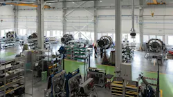 A maintenance hangar with a row of airplane engines inside
