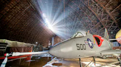 A historic plane with '500' written on the side parked inside a large hangar