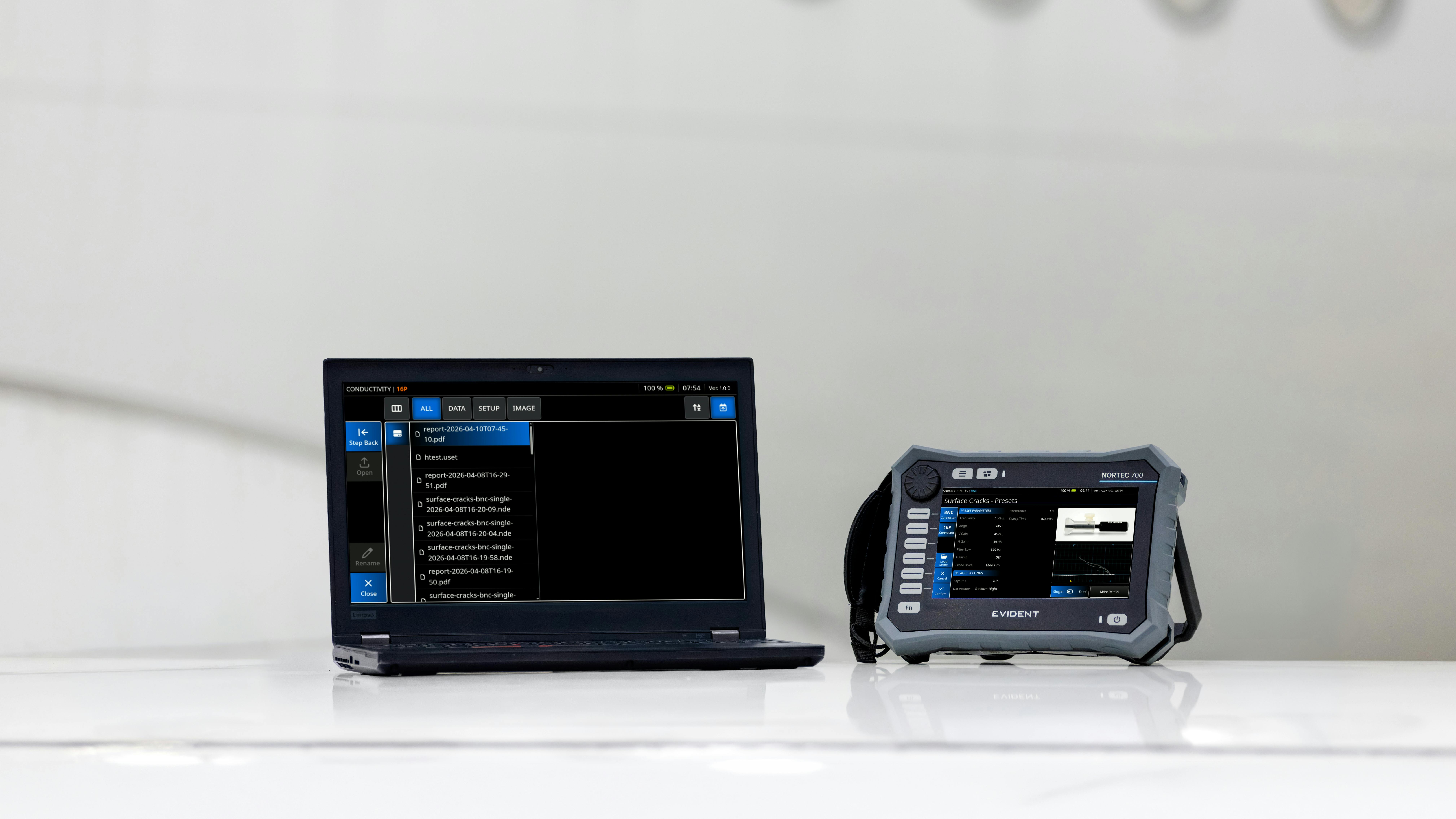 A laptop and tablet sitting on a platform in front of a white airplane