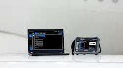 A laptop and tablet sitting on a platform in front of a white airplane