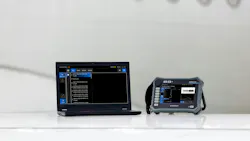 A laptop and tablet sitting on a platform in front of a white airplane
