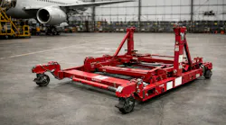 A red engine stand in a hangar