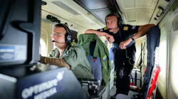 Kevin (left), a German military operator, and Benedikt Spangardt from Germany's Maritime Emergency Response Centre monitor a ship over the North Sea from a twin-engine propeller aircraft.