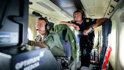 Kevin (left), a German military operator, and Benedikt Spangardt from Germany's Maritime Emergency Response Centre monitor a ship over the North Sea from a twin-engine propeller aircraft.