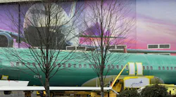 A MAX fuselage with a Spirit AeroSystems logo sits on a train at the Boeing factory in Renton, Washington, on Friday, March 1, 2024.